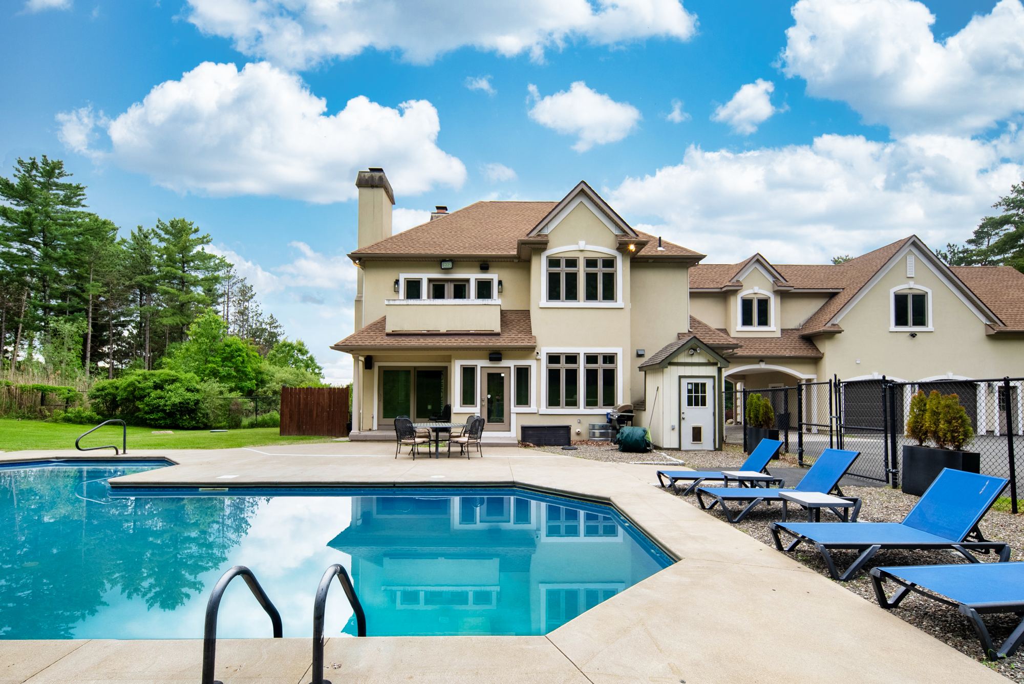 Resort-style pool with the house behind