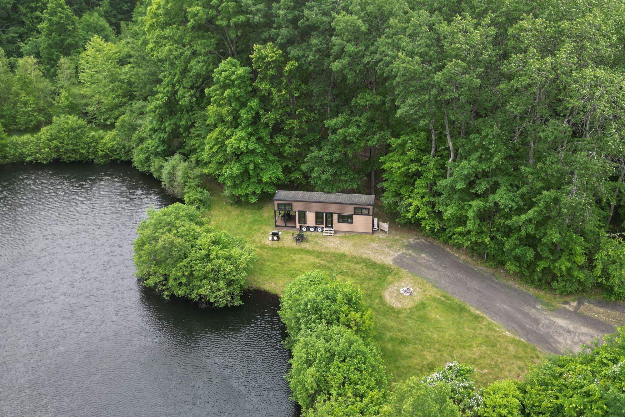 Drone view of the pond, woods and cabin